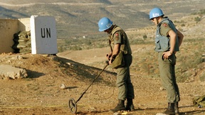 Due caschi blu ONU, impegnati in un'operazione di sminamento.