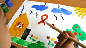 A nine-year-old girl, who is HIV-positive, paints at a UNICEF-supported day care centre which provides psychosocial care in Tashkent, Uzbekistan.