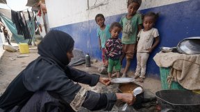 UN News: A mother-of-nine, who is suffering from malnutrition herself, cooks a meal for her children in an IDP camp in Aden, Yemen.
