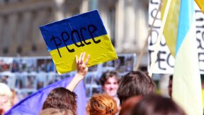 Peace sign on the ukrainian flag in protest manifestation against war in Ukraine on Republic Square of Paris on aug. 02. 2014 in Paris, France