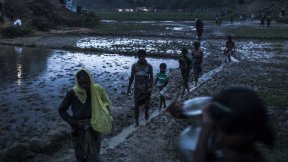 Rohingya refugees walk across the Balukhali settlement in Bangladesh's Cox Bazar district.