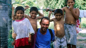 Un volontario a El Salvador mentre posa con bambini del posto, 1 gennaio 2001