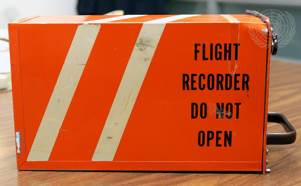 A shot of the cockpit voice recorder (CVR) found last week, photographed at the Air Safety Unit of the Department of Peacekeeping Operations.
Fred Eckhard, Spokesman for the Secretary-General, held a briefing today showing the CVR, and said that nothing heard so far on the tape links that CVR to the aircraft crash of 6 April 1994 in Rwanda. The Office of Internal Oversight Services took the CVR to the United States National Transportation Safety Board in Washington, D.C., where it was opened in the presence of experts from the International Civil Aviation Organization. Killed in the 1994 plane crash were Juvenal Habyarimana, President of Rwanda, and Cyprian Ntayamira, President of Burundi. Their deaths set off a chain of killings and massacres throughout Rwanda that year, with the death toll from the genocide mounting to more than 800,000 people, mostly minority Tutsis and moderate Hutus.