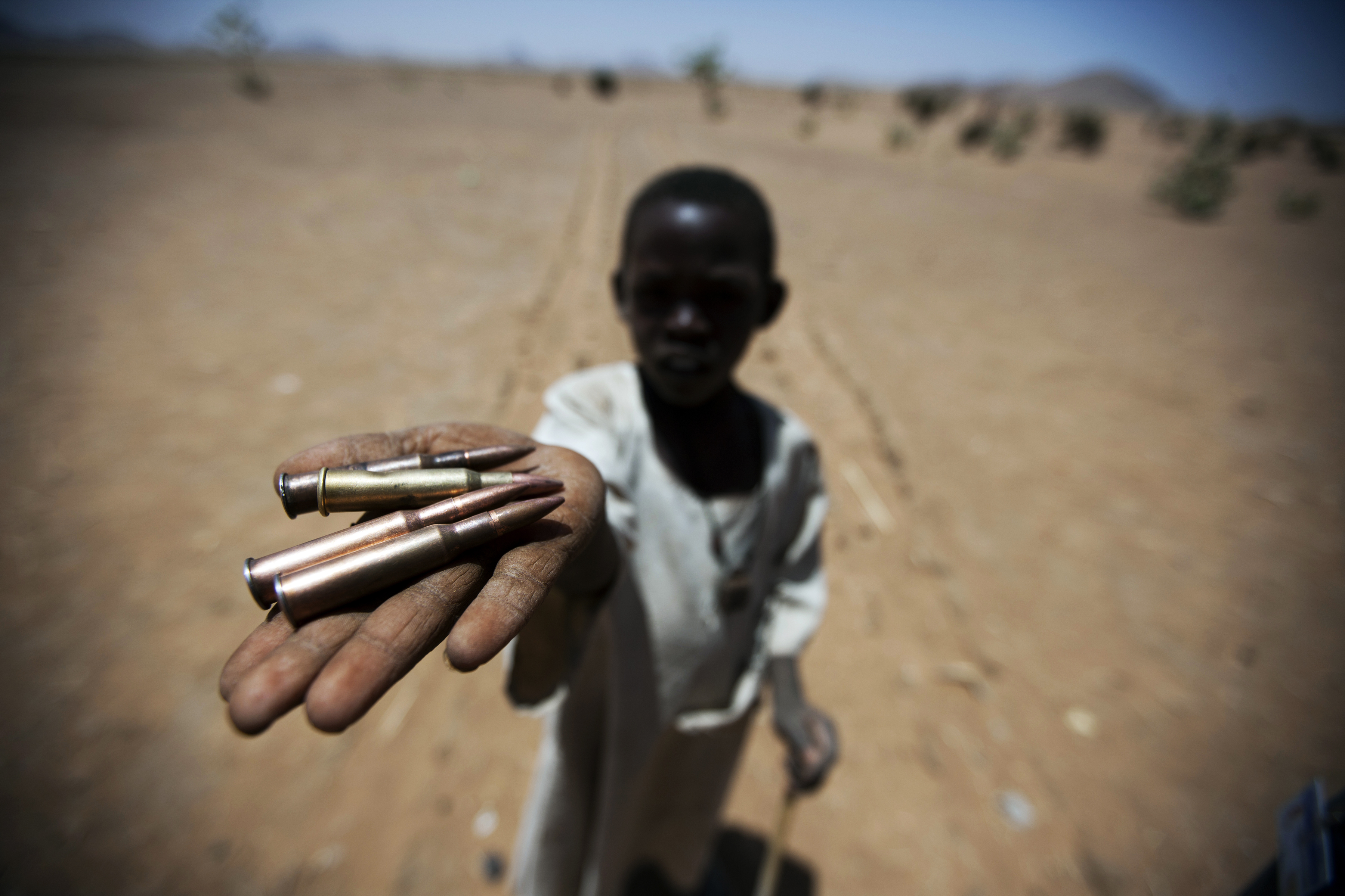 A child holds up bullets collected from the ground in Rounyn, a village about 15 kilometres from Shangil Tobaya, North Darfur. Most of the village’s population has fled to camps for internally displaced because of heavy fighting between Government of Sudan and rebel forces.