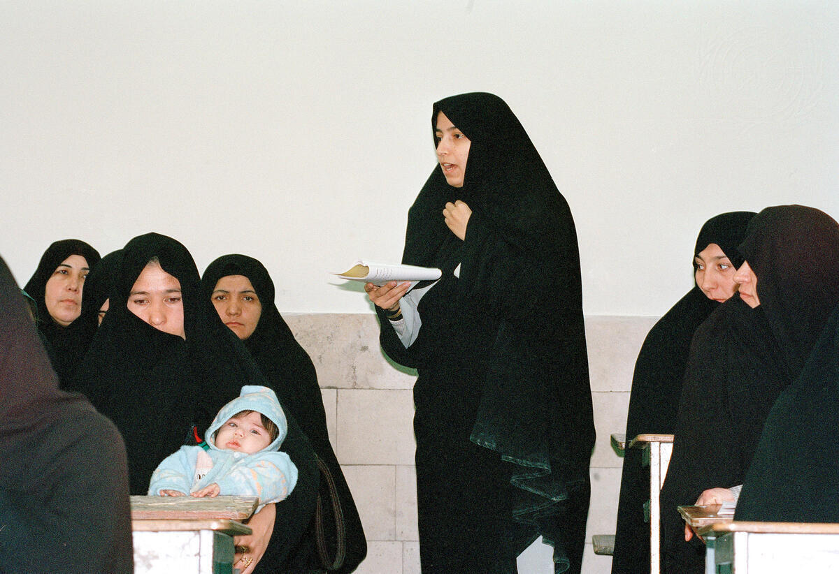 The United Nations Population Fund (UNFPA) and Iran's Literacy Movement Organization (LMO) are making efforts to integrate population and reproductive health messages at all levels of literacy classes in the selected provinces of Bushehr, Sistan and Baluchestan, Golestan and Kordestan and the semi-urban area of Islam Shahr, south of the capital, Tehran. The messages that are incorporated into the literacy curricula are on issues such as reproductive health, women's empowerment, and reproductive rights of women, gender equality, and male involvement in family life, education of the girl child and those related to adolescents. Some women bring their children to class as they haven't anyone to look after them. The student's ages range from nine to forty-five.
Students at Navid Danesh girl's high school.